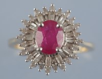 Lot 933 - A ruby and diamond dress ring, the oval facet...