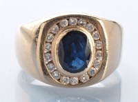 Lot 936 - A sapphire and diamond cluster ring, the oval...