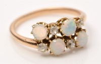 Lot 942 - An opal and diamond ring, set four circular...