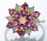 Lot 947 - An ruby and opal cluster ring, set with...