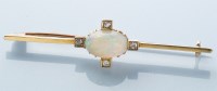 Lot 952 - An opal and diamond bar brooch, the oval opal...