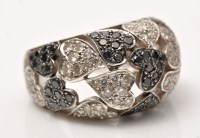 Lot 959 - A black and colourless diamond ring, in heart...