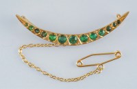 Lot 968 - An Edwardian demantoid garnet crescent brooch,...