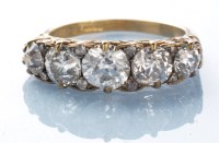 Lot 972 - A five stone diamond ring, the graduated...