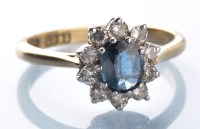 Lot 973 - A sapphire and diamond cluster ring, the oval...