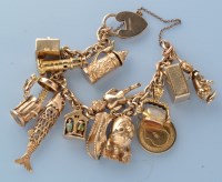 Lot 975 - A 9ct. yellow gold oval link charm bracelet,...