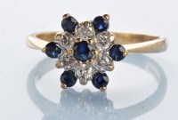 Lot 980 - A sapphire and diamond cluster ring, the...