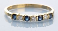 Lot 982 - A sapphire and diamond ring, the four circular...