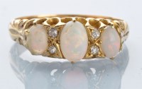 Lot 983 - An opal and diamond ring, the three graduated...