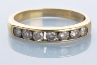 Lot 989 - A seven stone diamond ring, the brilliant cut...