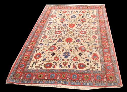 Lot 1017 - A Qum rug, the ivory ground under bold floral...