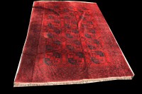 Lot 1034 - An Afghan carpet, with teke medallions on red...