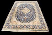 Lot 1036 - A Kashan carpet, the central rosette on blue...