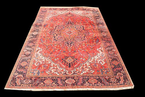 Lot 1037 - A Heriz carpet, with bold geometric design on...