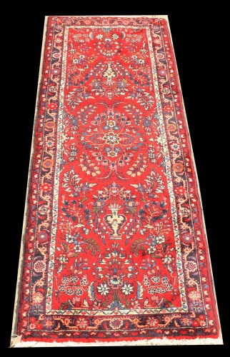 Lot 1059 - A Lilian runner, floral sprays on red ground,...