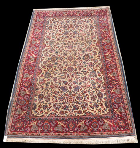 Lot 1065 - A Kashan rug, the foliate scrolls on ivory...