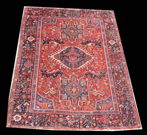 Lot 1066 - A Heriz rug, with triple geometric medallion,...