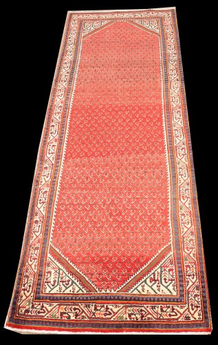 Lot 1079 - A Sarouk runner, the red ground with small...