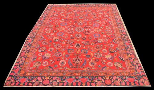 Lot 1085 - A Tabriz rug, the bold scrolling design on red...