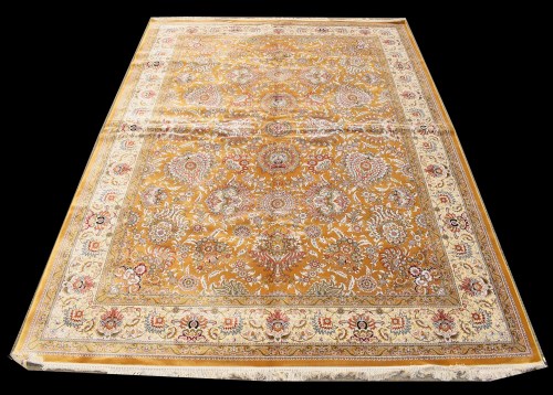 Lot 1088 - A silk carpet, the bold floral design on gold...