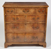 Lot 1192 - A George III walnut chest of three short and...