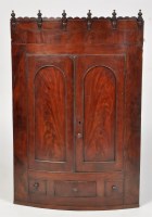 Lot 1218 - A George III mahogany hanging corner cabinet,...