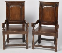 Lot 1226 - A pair of 20th Century oak open armchairs, the...