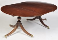 Lot 1255 - A Regency mahogany dining table, the demilune...