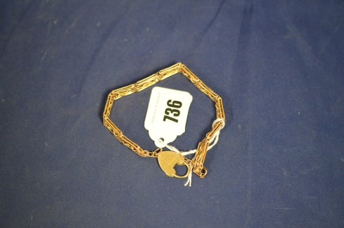 Lot 736 - A 9ct. yellow gold fancy gate link bracelet,...