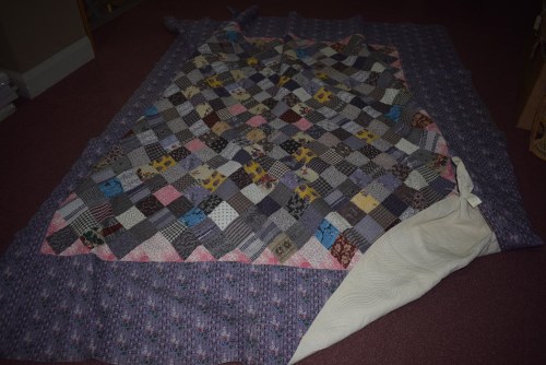 Lot 1095 - An early 20th Century patchwork Durham quilt;...