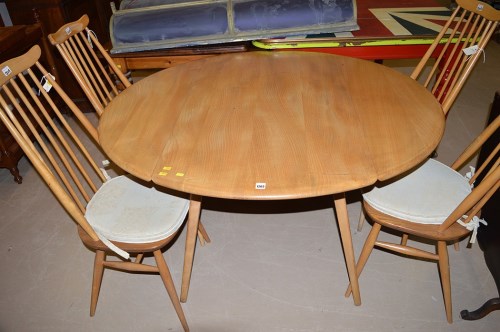 Lot 1203 - An Ercol style elm drop leaf dining table,...
