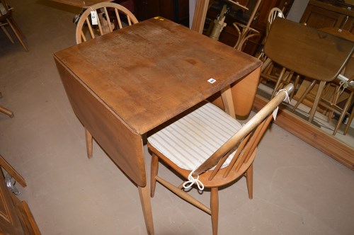 Lot 1211 - An elm Ercol drop leaf dining table, 136cms...