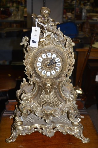 Lot 1342 - A rococo style brass mantel clock and stand,...