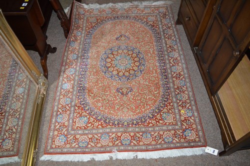Lot 1399 - A 20th Century part silk Persian rug, pink and...