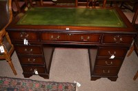 Lot 593 - A reproduction mahogany kneehole desk, inset...