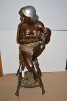 Lot 712 - An Art Deco spelter figure of a lady in gold...