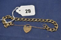 Lot 29 - A 9ct. yellow gold curb link bracelet,...