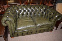 Lot 663 - A buttoned back green leather two-seater...