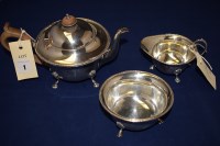 Lot 1 - A George V silver teapot, sugar bowl and cream...
