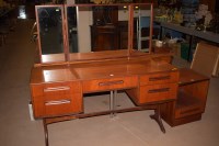 Lot 552 - A G-Plan teak dressing table with mirror back,...