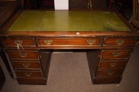 Lot 592 - An early 20th Century oak kneehole desk, inset...