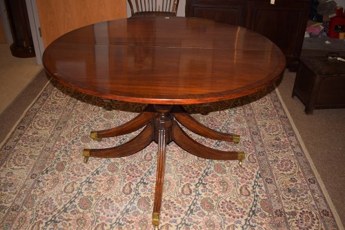 Lot 749 - A Regency mahogany dining table, the demilune...