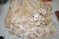 Lot 1298 - A late 19th/early 20th Century cream silk and...