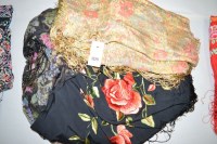 Lot 1329 - Early 20th Century shawls, one black with red...