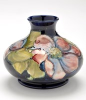 Lot 328 - Moorcroft blue ground 'Clematis' squat vase,...