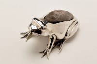 Lot 636 - An Edwardian silver frog pattern pin cushion,...