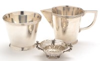 Lot 677 - A white metal cream jug and sugar bowl, in the...