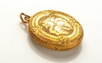 Lot 730 - A Victorian locket pendant, oval and engraved...