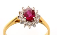 Lot 739 - A ruby and diamond cluster ring, the central...