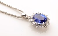 Lot 757 - A tanzanite and diamond cluster pendant, the...